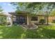 Home exterior with screened porch and landscaped yard at 8231 Dunham Station Dr, Tampa, FL 33647