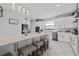 Modern kitchen with white cabinets, a large island, and quartz countertops at 8231 Dunham Station Dr, Tampa, FL 33647