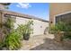 Private backyard with a stone patio, lush greenery, and a fenced enclosure at 8231 Dunham Station Dr, Tampa, FL 33647