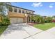 Two-story house with double garage and manicured lawn at 8231 Dunham Station Dr, Tampa, FL 33647