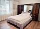 Bedroom with a queen bed, built-in cabinets, and wood floors at 8231 Dunham Station Dr, Tampa, FL 33647
