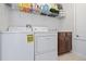 Laundry room with washer, dryer, and shelving at 8231 Dunham Station Dr, Tampa, FL 33647