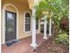 Elegant front entrance with arched entryway and brick walkway at 8231 Dunham Station Dr, Tampa, FL 33647