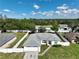 Aerial view showcasing a single-story house with a gray roof, a two-car garage, and a fenced yard at 10255 Norwick St, Spring Hill, FL 34608