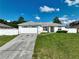 Single story house exterior with a two-car garage and well maintained lawn at 10255 Norwick St, Spring Hill, FL 34608