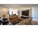 Spacious living room with two sofas, large TV, and hardwood floors at 10255 Norwick St, Spring Hill, FL 34608