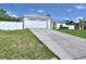House exterior featuring a white single-story home with a two-car garage and a concrete driveway at 10255 Norwick St, Spring Hill, FL 34608