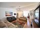 Living room with two sofas, large TV, and hardwood floors at 10255 Norwick St, Spring Hill, FL 34608