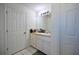 Bathroom with vanity, sink, and a large mirror at 10255 Norwick St, Spring Hill, FL 34608
