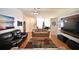 Living room with two sofas, large TV, and hardwood floors at 10255 Norwick St, Spring Hill, FL 34608
