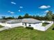 Single-story home with a white exterior and a fenced yard at 10255 Norwick St, Spring Hill, FL 34608