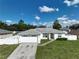 One-story home with white exterior, two-car garage, and landscaped lawn at 10255 Norwick St, Spring Hill, FL 34608