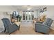 Bright living room with water view, comfy seating, and a large TV at 25188 Marion Ave # A103, Punta Gorda, FL 33950