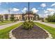 Gated community entrance with guard booth and landscaping at 25188 Marion Ave # A103, Punta Gorda, FL 33950
