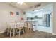 Bright dining area with white table and chairs, adjacent to the kitchen at 25188 Marion Ave # A103, Punta Gorda, FL 33950