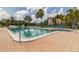 Community pool with lounge chairs and landscaping at 25188 Marion Ave # A103, Punta Gorda, FL 33950