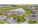 Aerial view of a residential neighborhood with a lake at 8064 Olive Brook Dr, Wesley Chapel, FL 33545