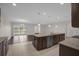 Modern kitchen with island overlooking Gathering room at 8064 Olive Brook Dr, Wesley Chapel, FL 33545