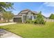 One-story home with a two-car garage and landscaped yard at 8064 Olive Brook Dr, Wesley Chapel, FL 33545