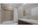 Bathroom with shower/tub combo and dark vanity at 8064 Olive Brook Dr, Wesley Chapel, FL 33545