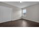 Simple bedroom with dark tile flooring and a window at 8064 Olive Brook Dr, Wesley Chapel, FL 33545