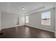 Spacious bedroom with dark tile flooring and two windows at 8064 Olive Brook Dr, Wesley Chapel, FL 33545