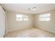 Bright bedroom with tile floors and two windows at 1102 Croydon Ln, Holiday, FL 34691