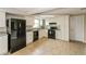 Modern kitchen featuring white cabinets and black appliances at 1102 Croydon Ln, Holiday, FL 34691