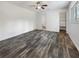 Spacious bedroom with wood-look floors and an ensuite bathroom at 3451 Sage St, Port Charlotte, FL 33948