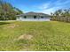 Large backyard with grassy area and wooden fence at 3451 Sage St, Port Charlotte, FL 33948