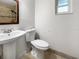 Bathroom with pedestal sink, toilet, and tile floor at 3451 Sage St, Port Charlotte, FL 33948
