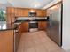 Modern kitchen with stainless steel appliances and wood cabinets at 3451 Sage St, Port Charlotte, FL 33948