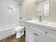 Modern bathroom with white vanity and tub at 780 Darwin Rd, Venice, FL 34293