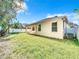 Tan house exterior with covered patio and grassy backyard at 423 Durham Shore Ct, Apollo Beach, FL 33572
