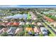 Aerial view of a residential neighborhood with houses, a lake, and lush greenery at 423 Durham Shore Ct, Apollo Beach, FL 33572