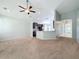 Spacious living room with carpeting and a view of the kitchen at 423 Durham Shore Ct, Apollo Beach, FL 33572