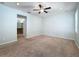 Primary bedroom with carpet, ceiling fan and access to bathroom at 423 Durham Shore Ct, Apollo Beach, FL 33572