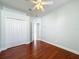 Bedroom with wood floors, double door closet, and access to bathroom at 423 Durham Shore Ct, Apollo Beach, FL 33572