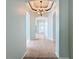 Elegant entryway with arched hallway and chandelier at 423 Durham Shore Ct, Apollo Beach, FL 33572