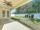 Covered patio overlooks a fenced backyard with grassy area at 423 Durham Shore Ct, Apollo Beach, FL 33572