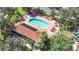 Kidney-shaped community pool with a solar-heated patio and lounge chairs at 423 Durham Shore Ct, Apollo Beach, FL 33572