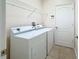 Laundry room with washer, dryer, and built-in shelving at 423 Durham Shore Ct, Apollo Beach, FL 33572