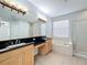 Bathroom with double vanity, soaking tub, and separate shower at 423 Durham Shore Ct, Apollo Beach, FL 33572