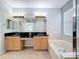 Primary bathroom with double sinks, soaking tub and walk-in shower at 423 Durham Shore Ct, Apollo Beach, FL 33572