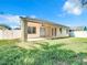 Tan house exterior with covered patio and grassy backyard at 423 Durham Shore Ct, Apollo Beach, FL 33572