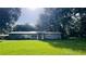 Ranch-style home with a spacious lawn and mature trees at 4905 Nesmith Rd, Plant City, FL 33567