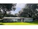 Ranch-style home with a spacious lawn and mature trees at 4905 Nesmith Rd, Plant City, FL 33567