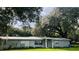 Ranch-style home with a spacious lawn and mature trees at 4905 Nesmith Rd, Plant City, FL 33567