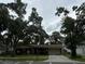 Ranch-style home with mature trees and driveway at 4706 W Estrella St, Tampa, FL 33629