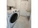 Laundry room with LG washer and dryer and built-in shelving at 1847 Wheeling Ave, North Port, FL 34288